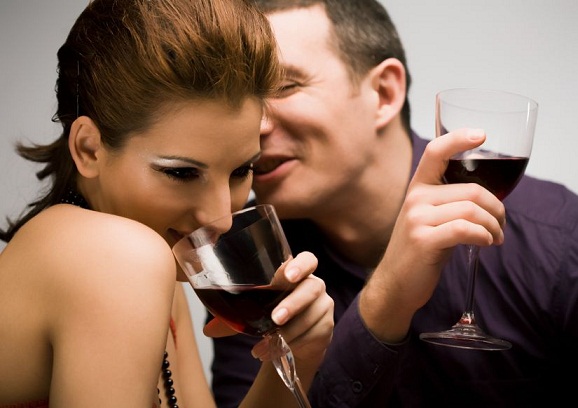 Young couple drinking wine and having fun